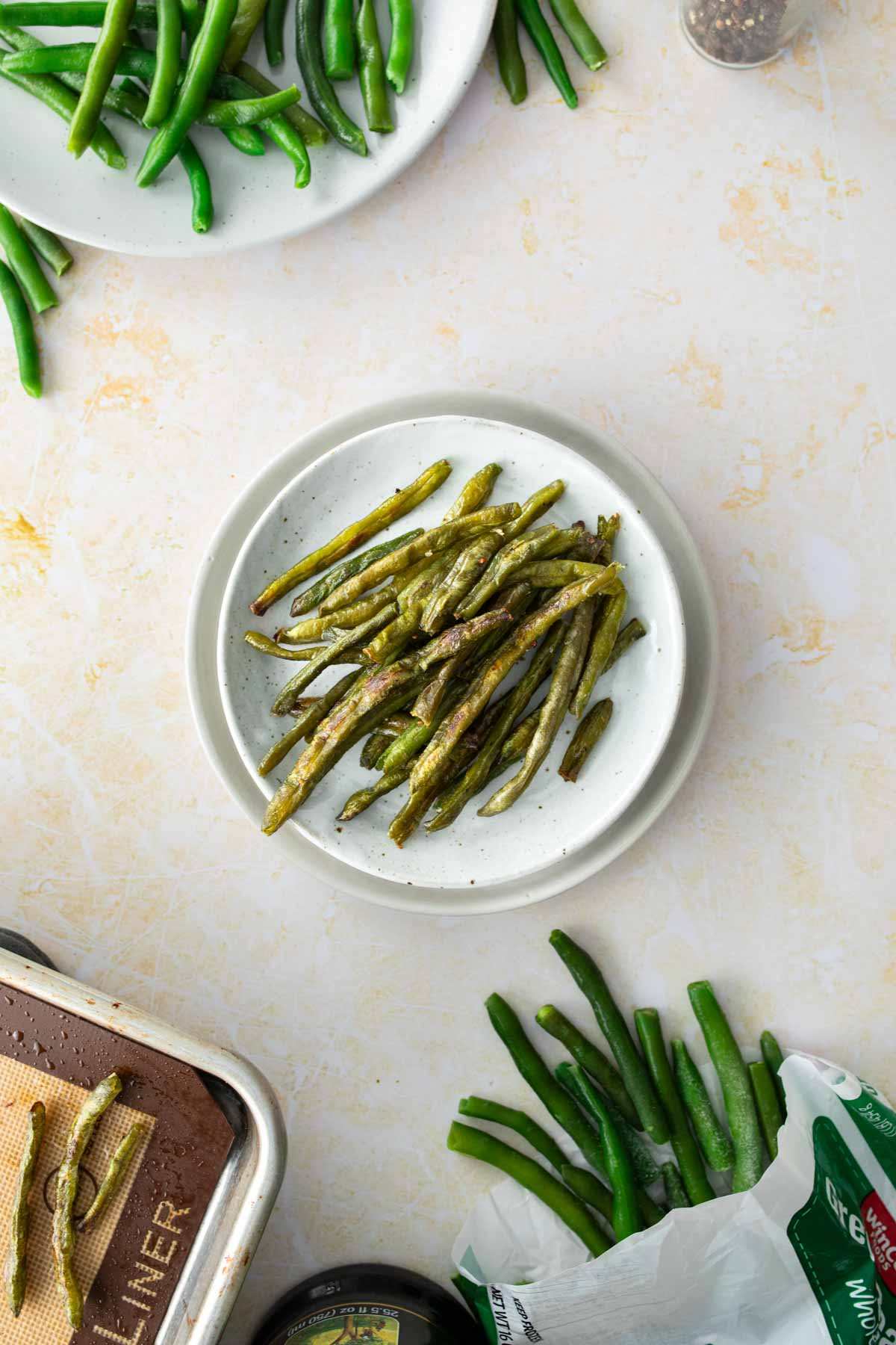 roasted green beans on plate, with green beans around