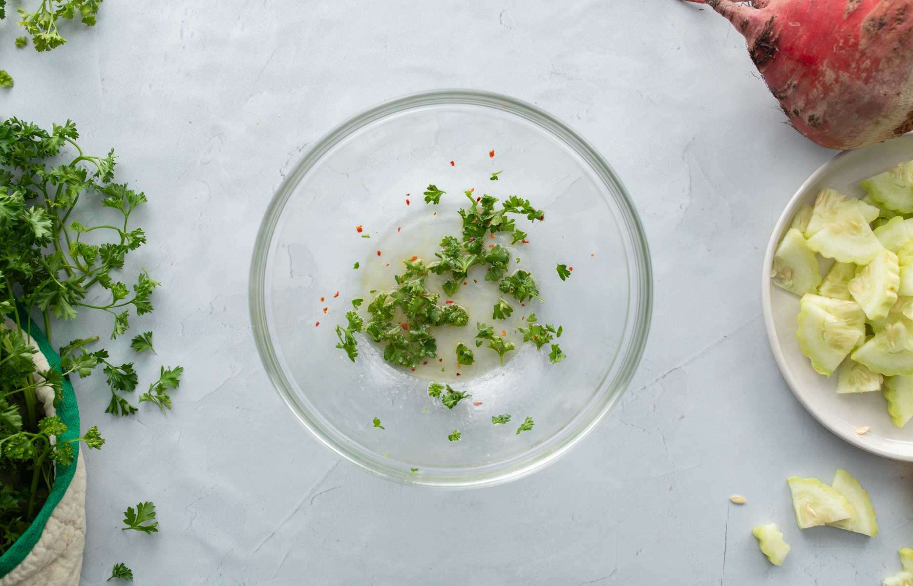 salad dressing with parsley in glass bowl