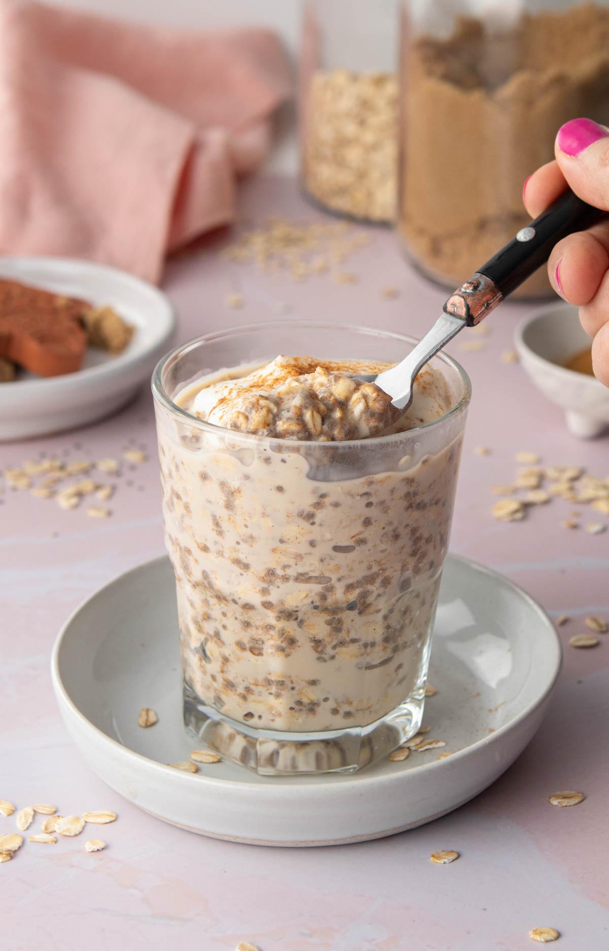 spoon of cinnamon roll overnight oats in glass