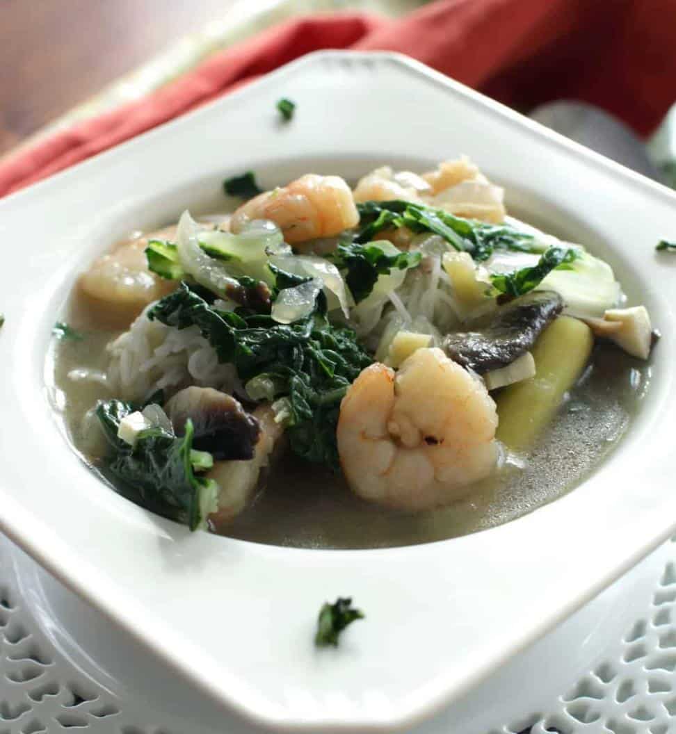 bowl of soup with shrimp and spinach