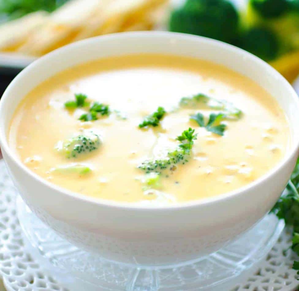 broccoli and cheddar soup in bowl with parsley on top