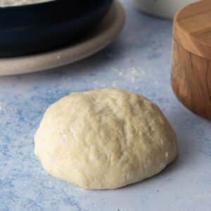 round pizza dough ball on table