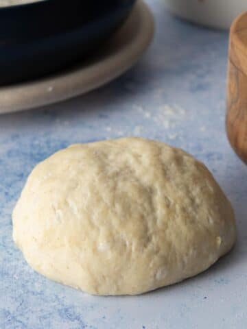 round pizza dough ball on table