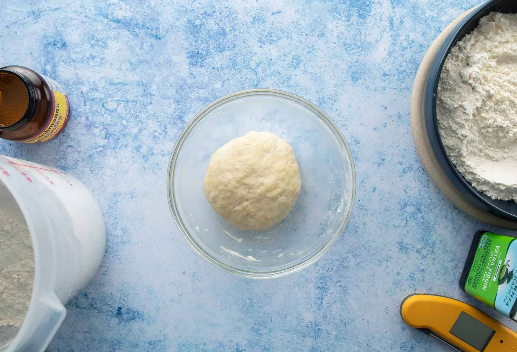 proofed pizza dough in bowl