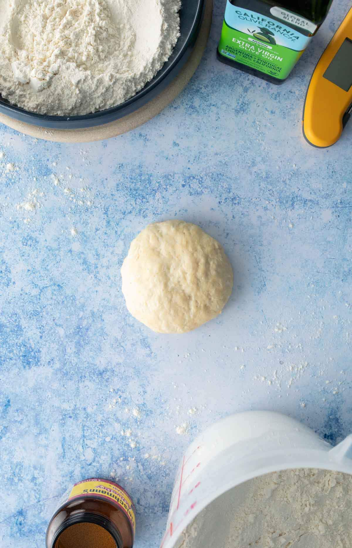 single serving pizza dough with ingredients on table