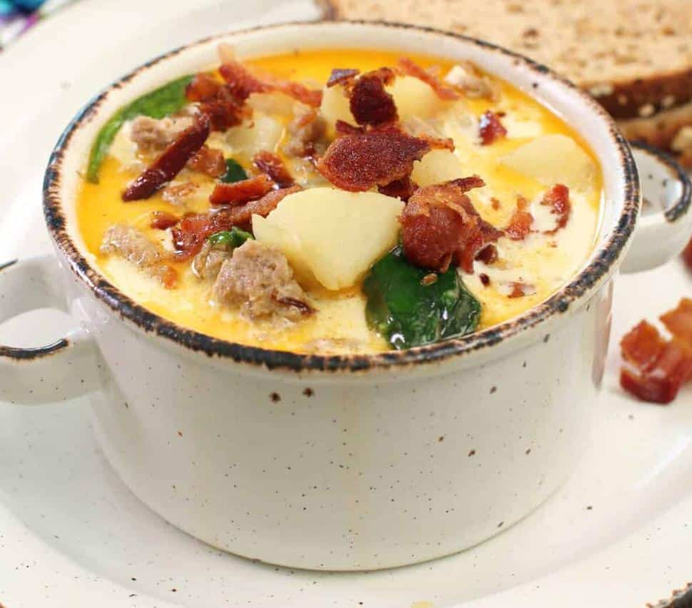 bowl of creamy potato soup with bacon and spinach