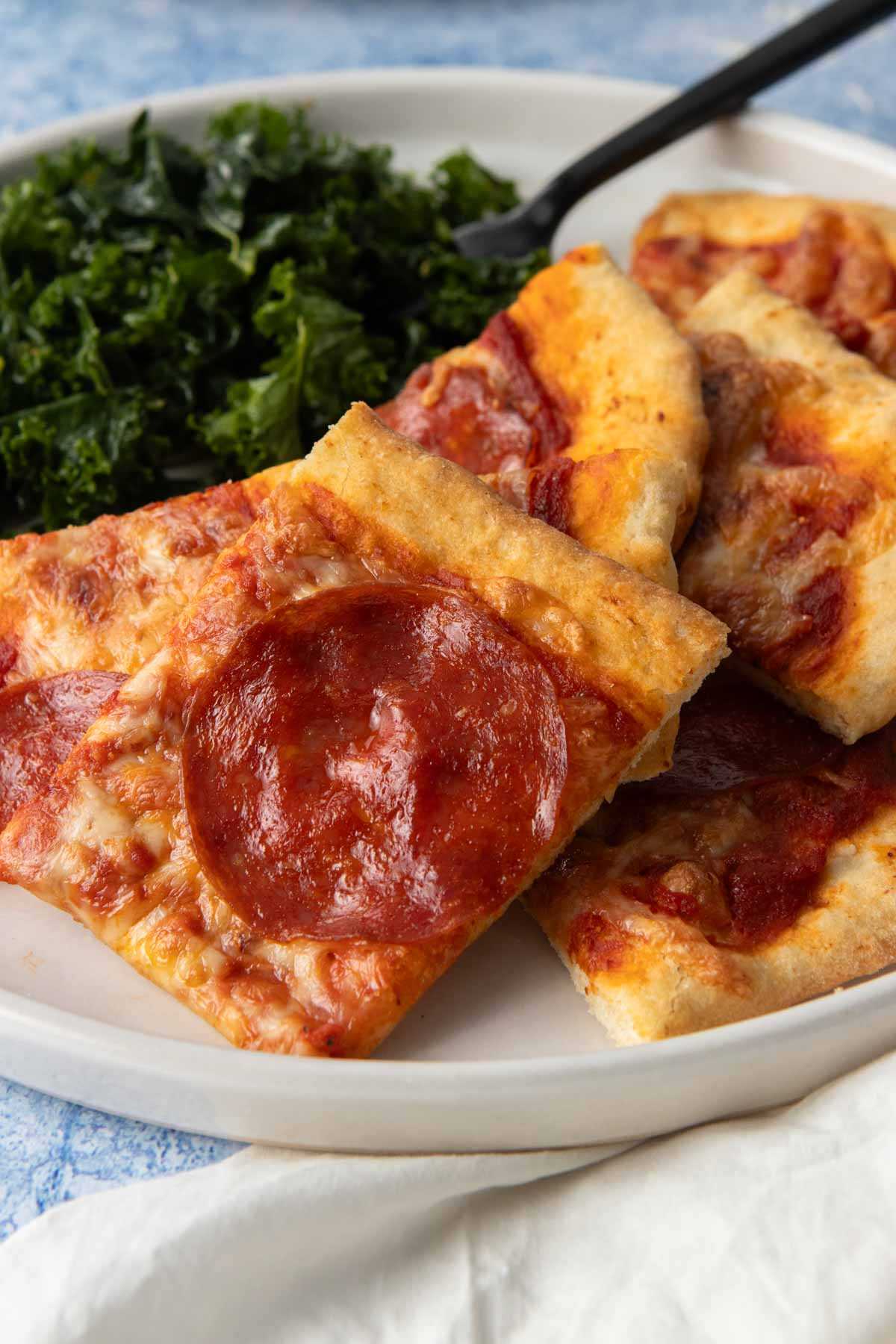 stack of pepperoni pizza slices on plate