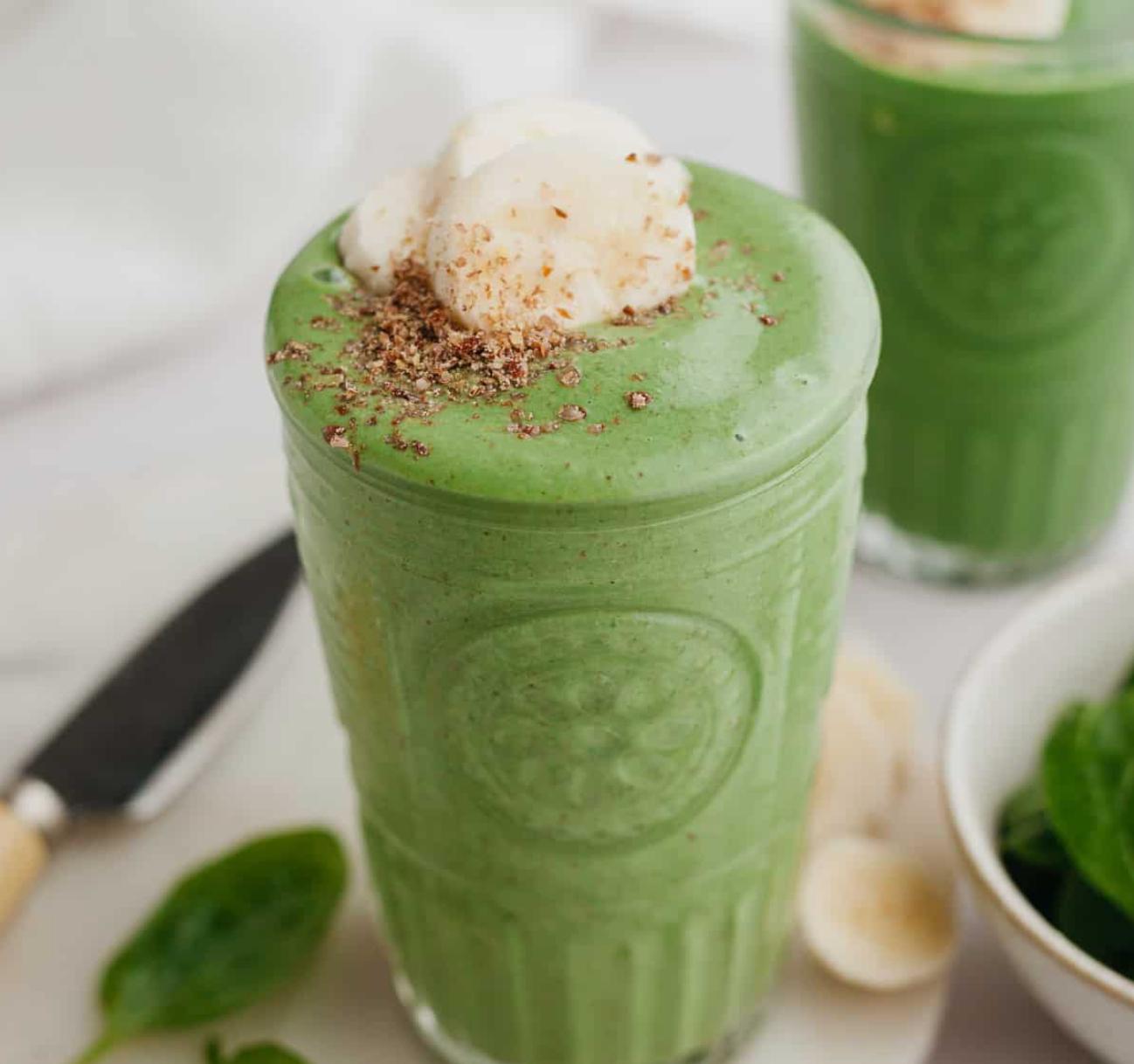 green smoothie with banana slices and toppings