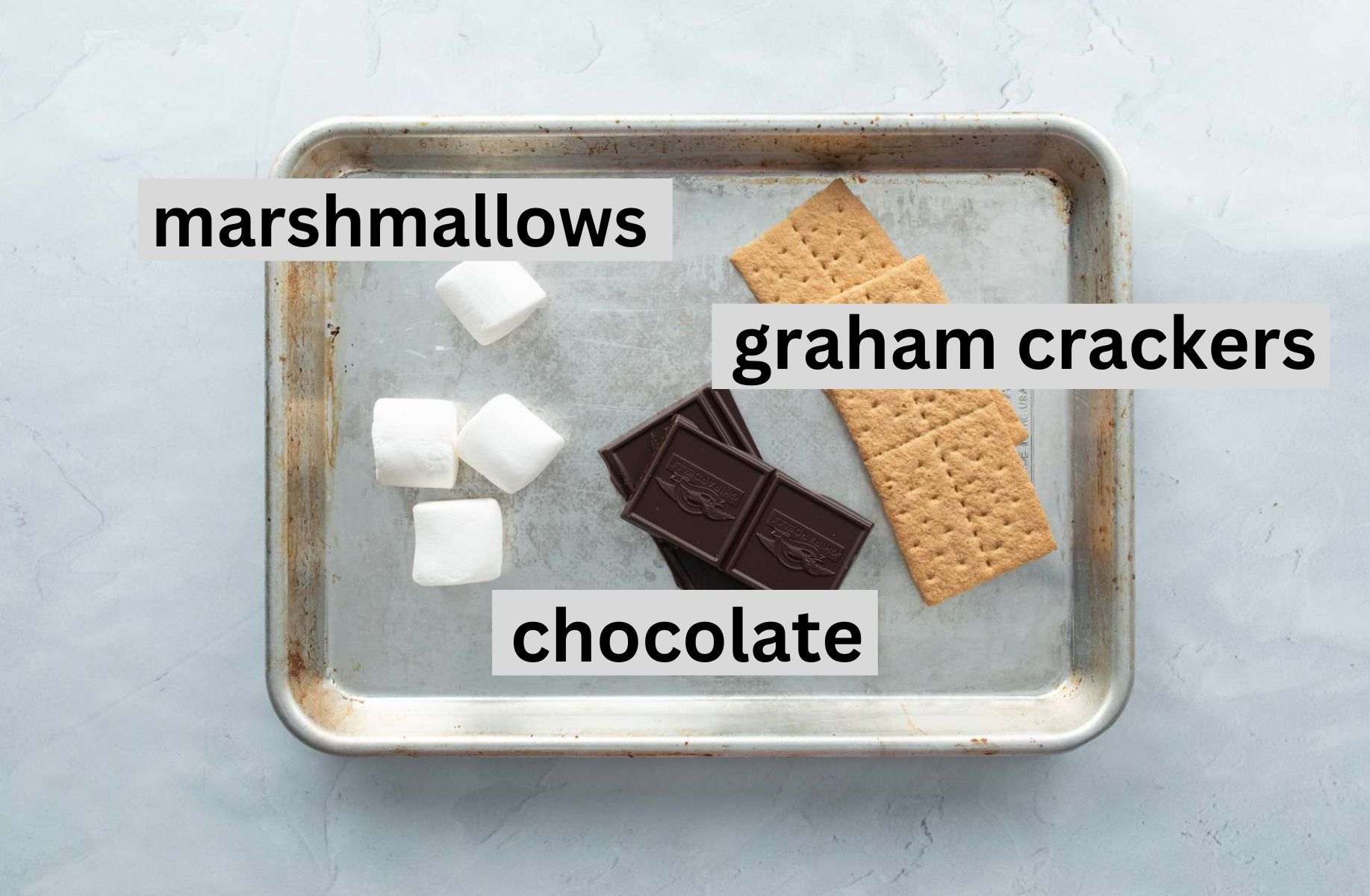 s'mores ingredients on pan, with text overlay