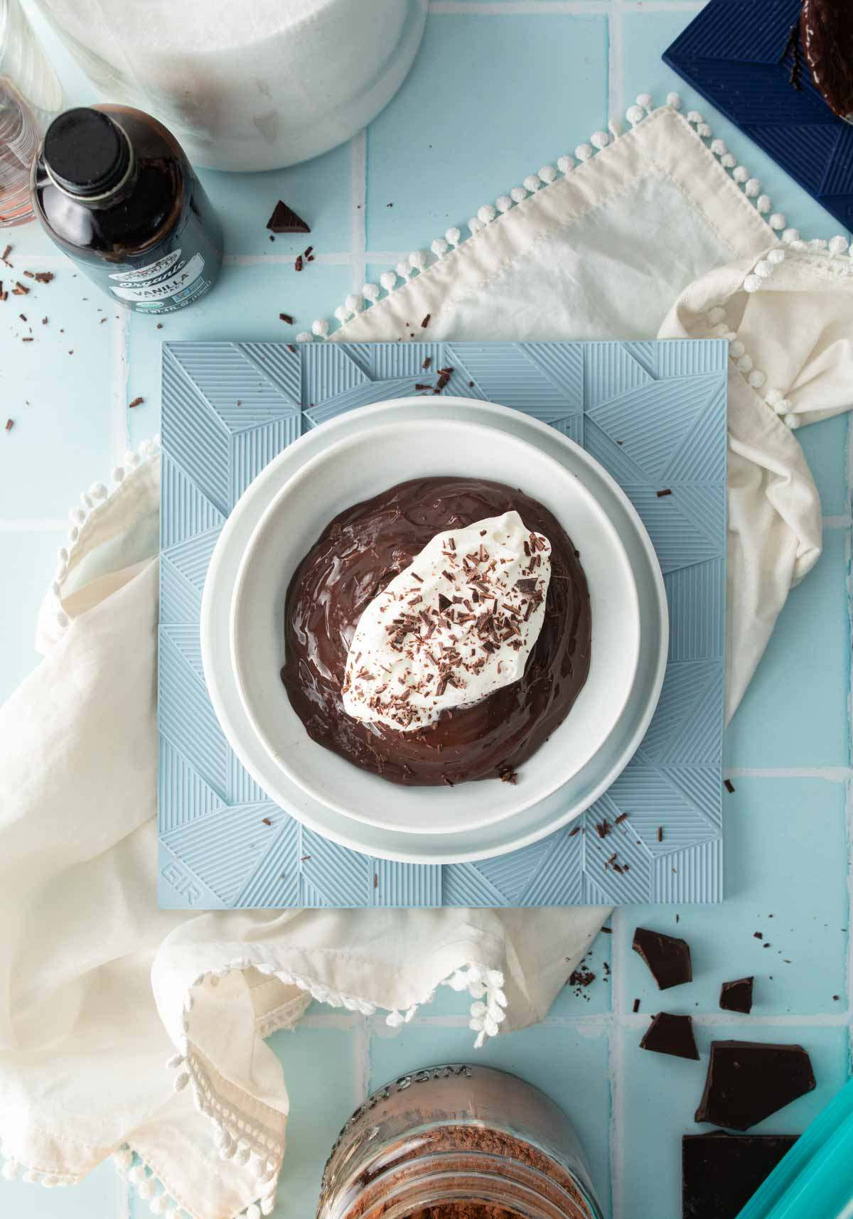bowl of chocolate pudding with whipped cream and chocolate topping