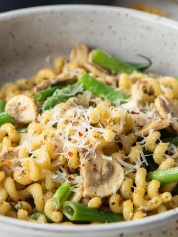 close up of mushroom, green bean pasta in bowl