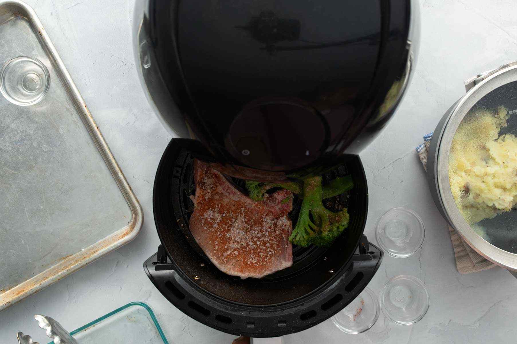 pork chop and broccoli in Air Fryer basket